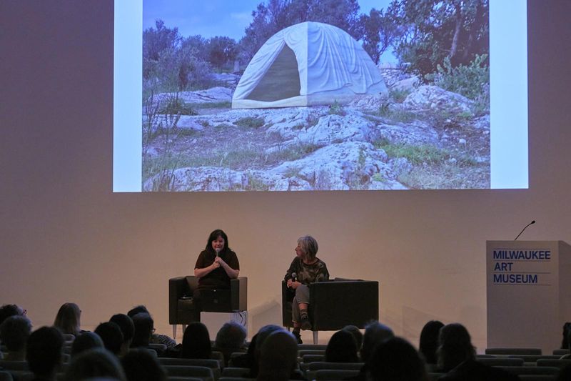 Three women talking on a panel