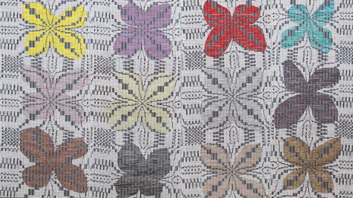 Woven art with flowers in various colors
