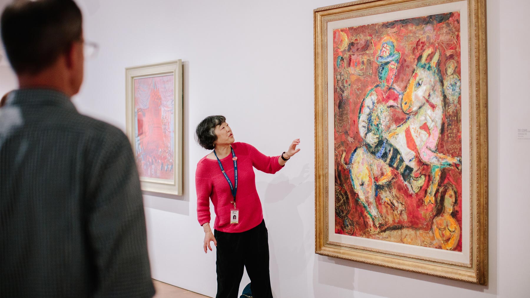 Woman giving a docent-led tour of a work of art to a small group