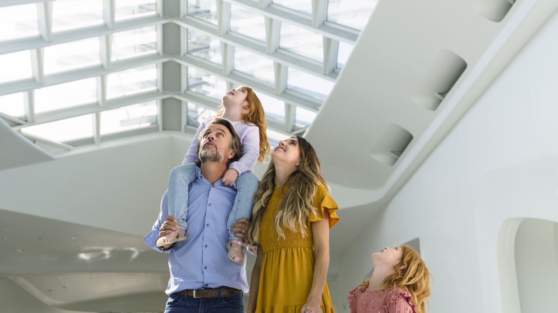 Family looking at the architecture of the Milwaukee Art Museum's Windhover Hal