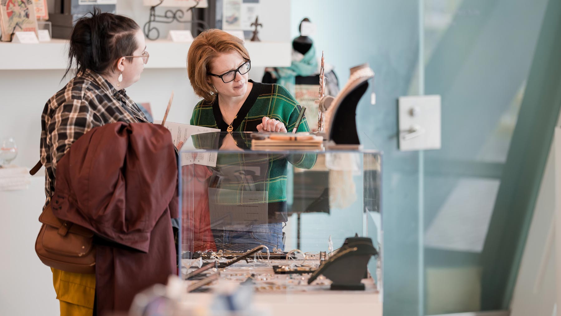 Two people looking at items in the Museum Store