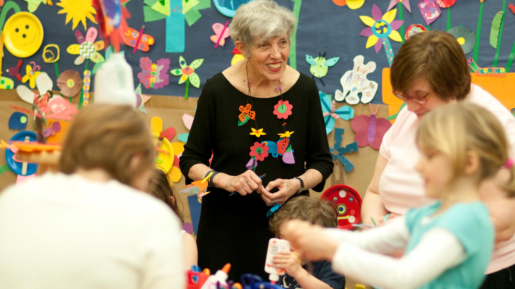 Lois Ehlert with a group of children making art