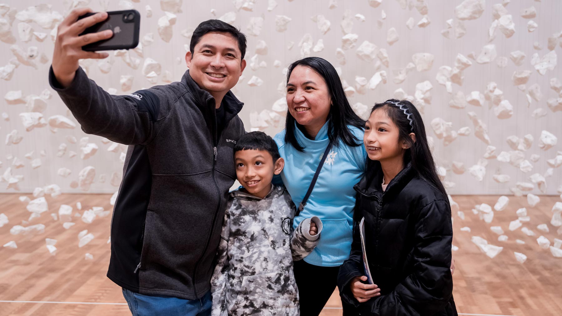 Man taking a photo with his family