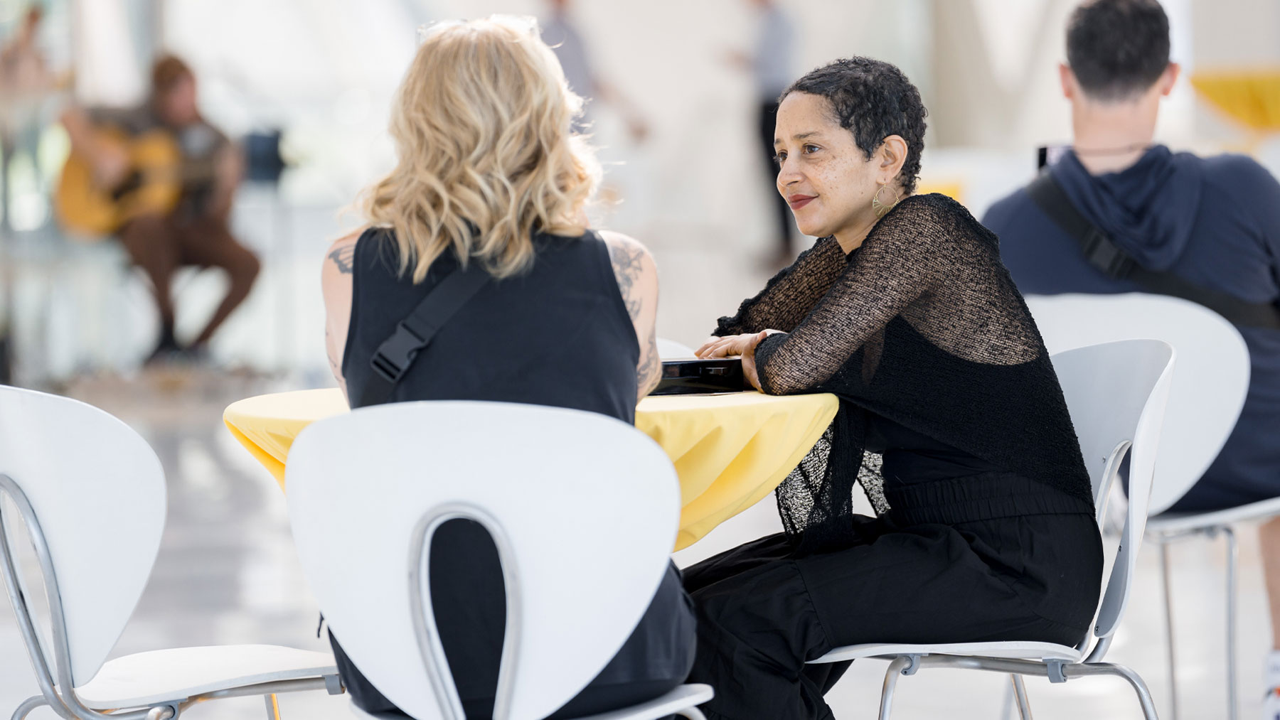 Two women sitting at a table talking