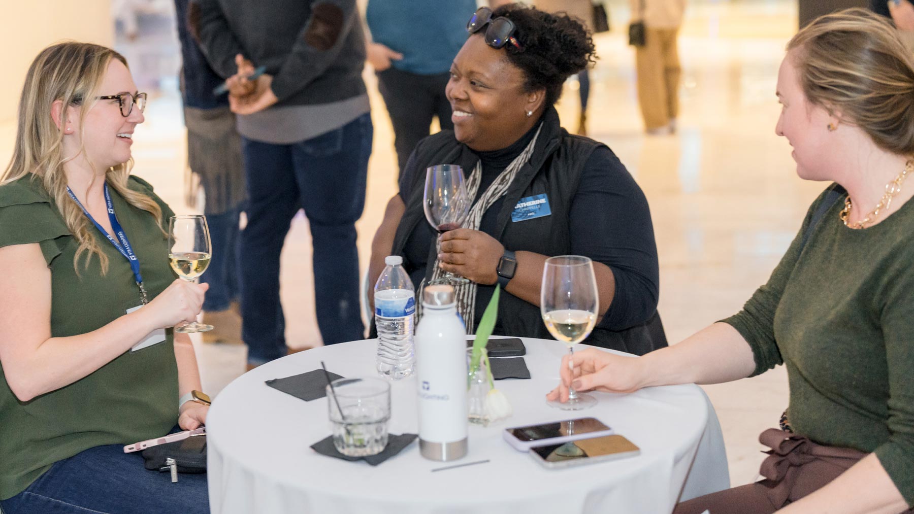 Three women talking around a table