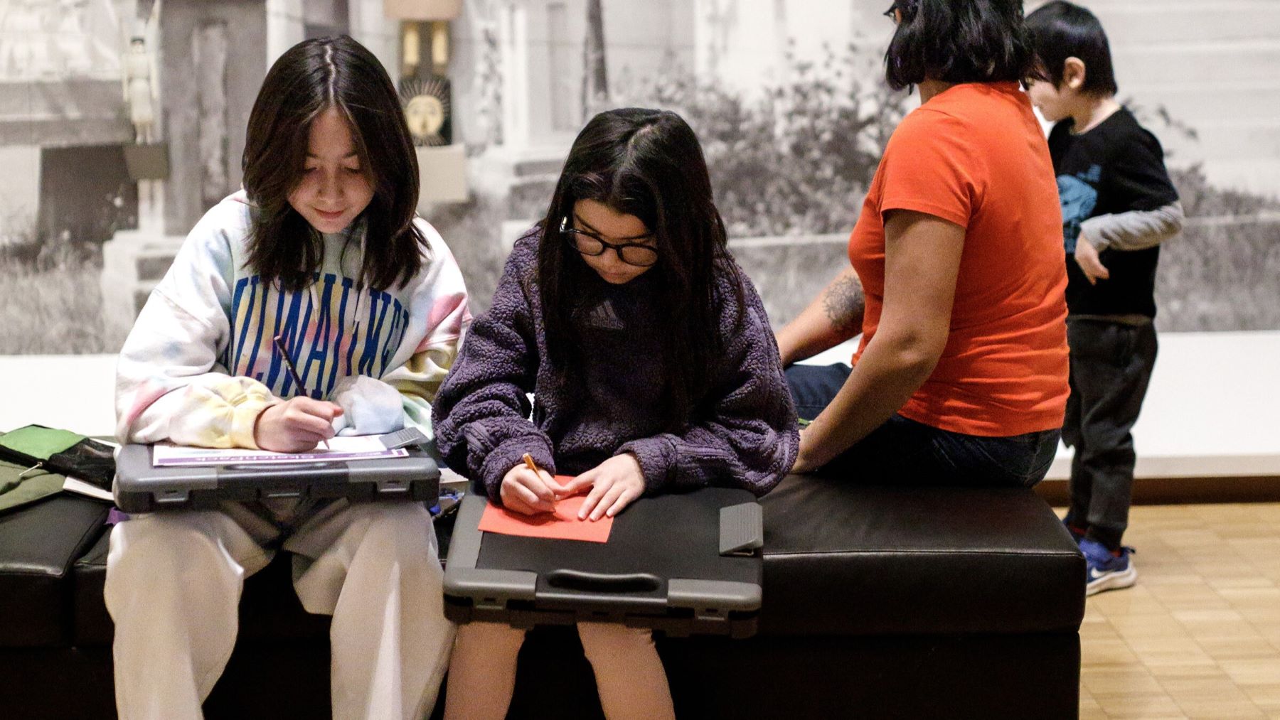 Young people using ArtPack Stations in the gallery