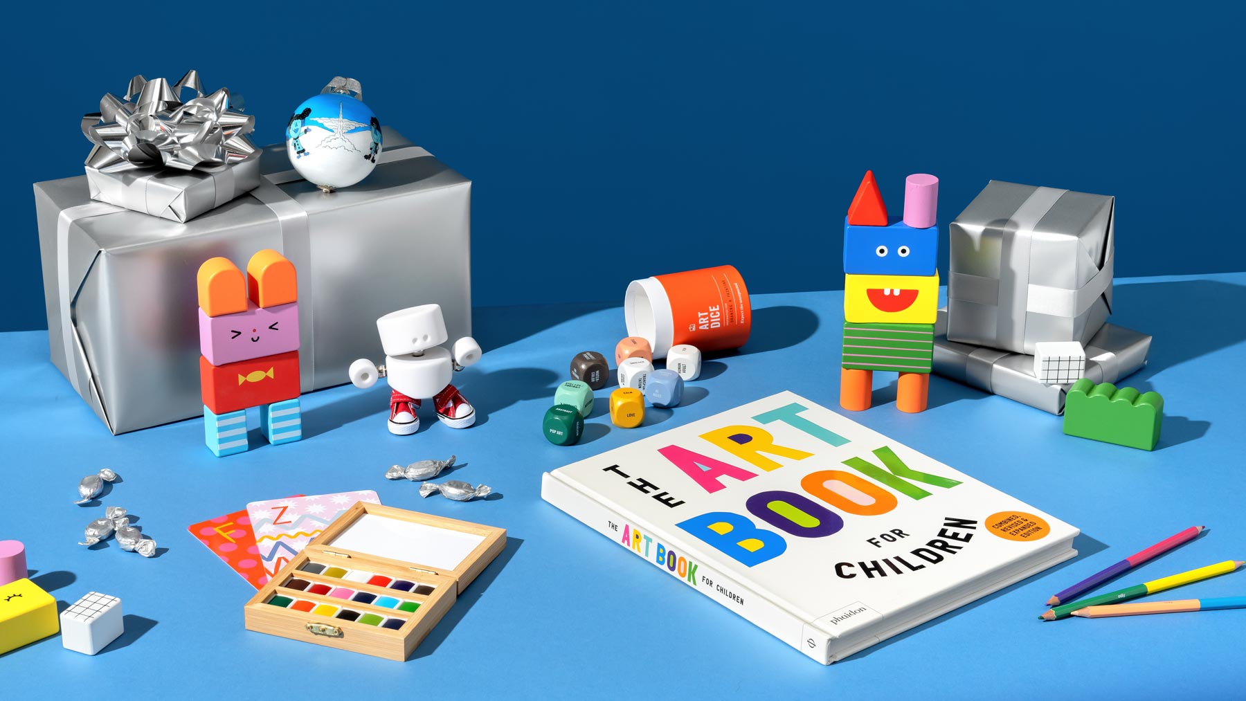 Collection of store items including and art book for children and building blocks