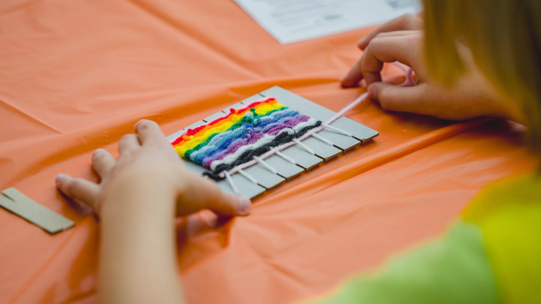 Little girl making yarn art