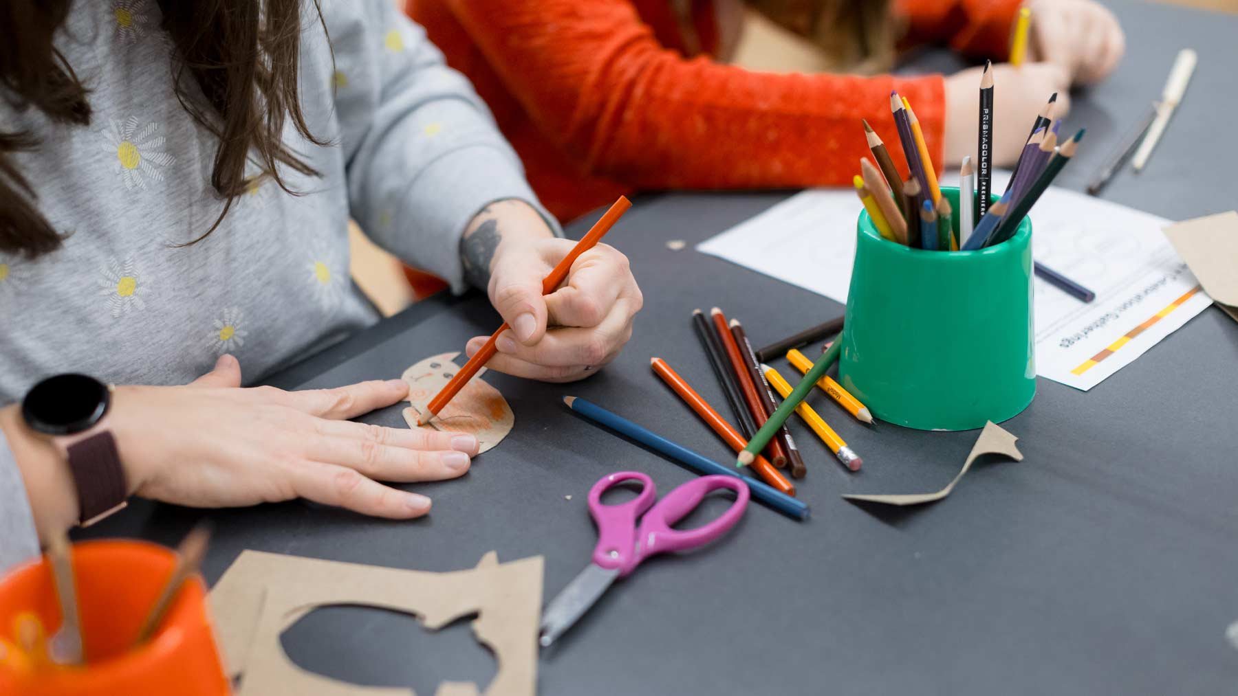 Three teens creating art with paper