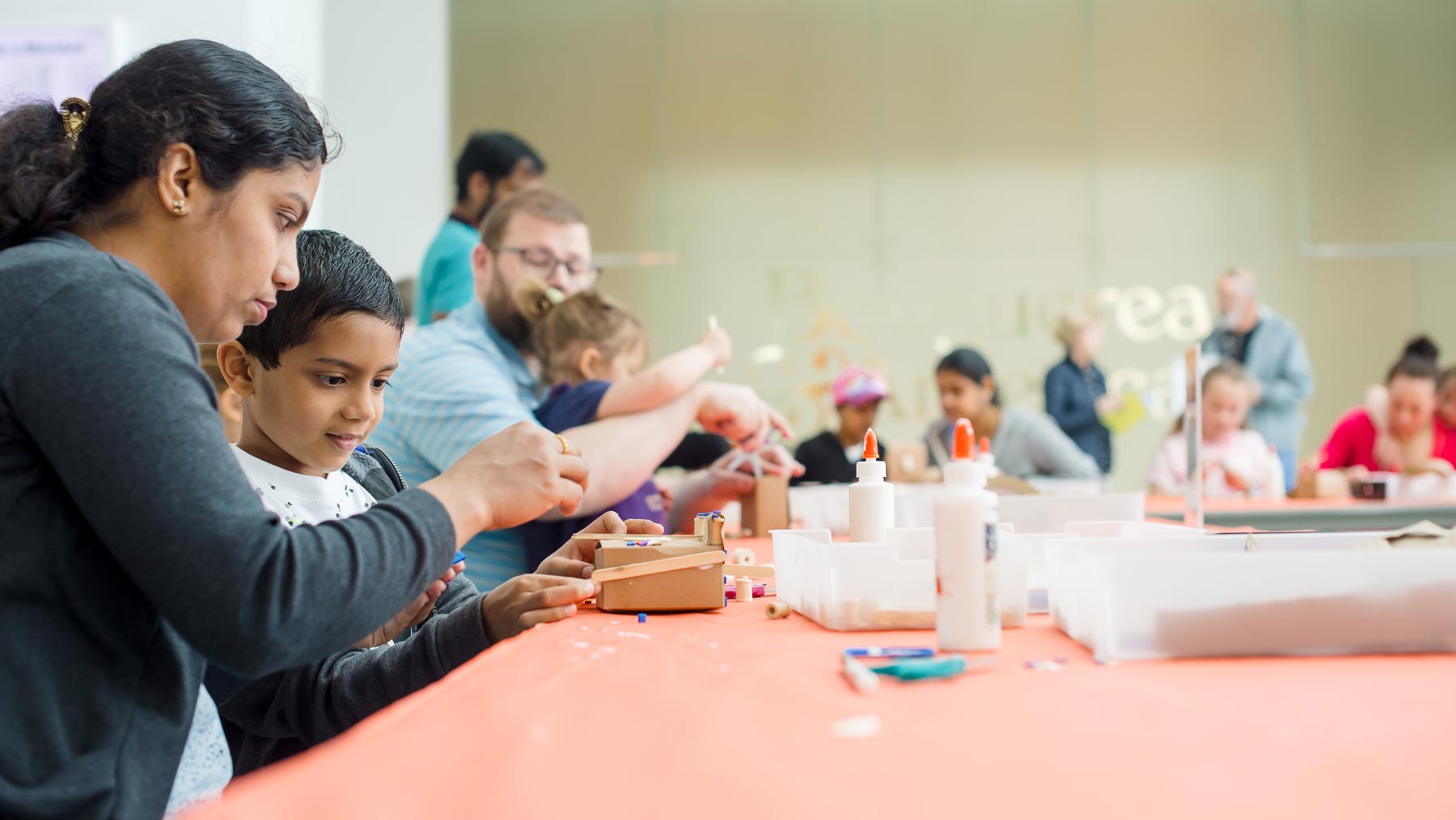 Group of families making art together in Windhover Hall