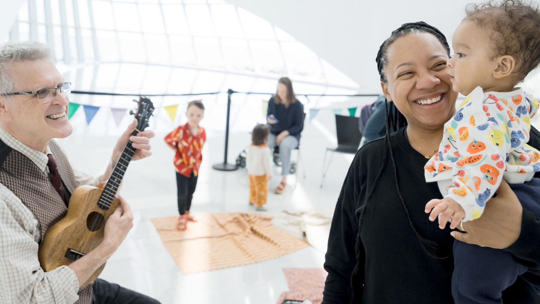 Woman with her child talking with a musical performer