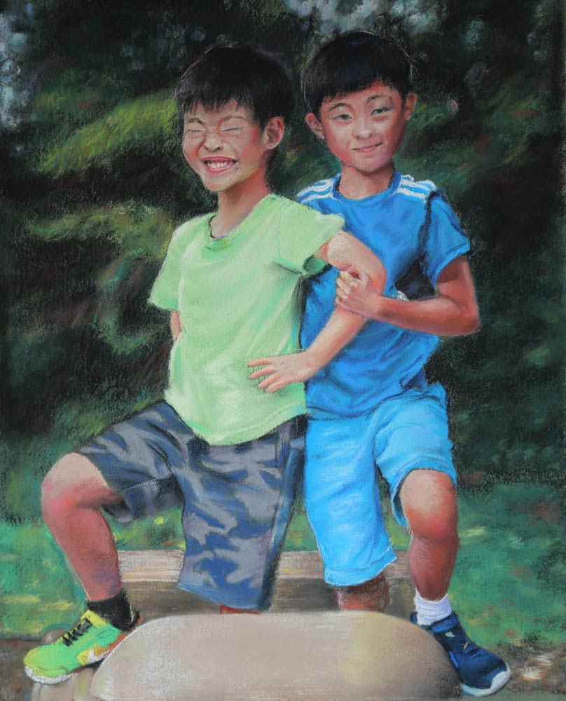 Two young Asian boys posing together with their arms interlocked