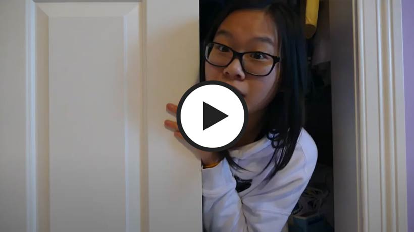 Teen girl peeking out from inside a closet