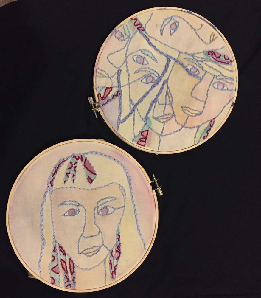 Two embroidered pieces, one of a single face and the other with multiple faces connected together