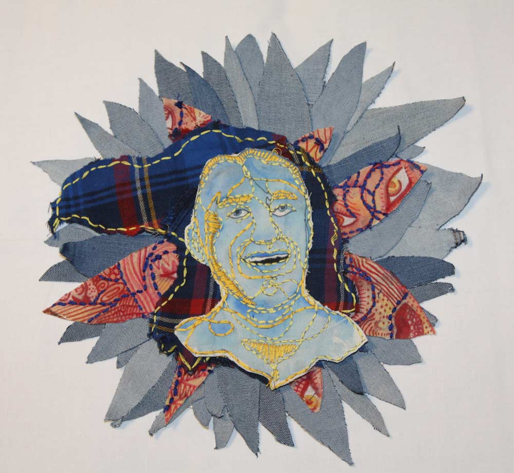 Face with embroidered outlines on top of cut outs in the shape of a flower