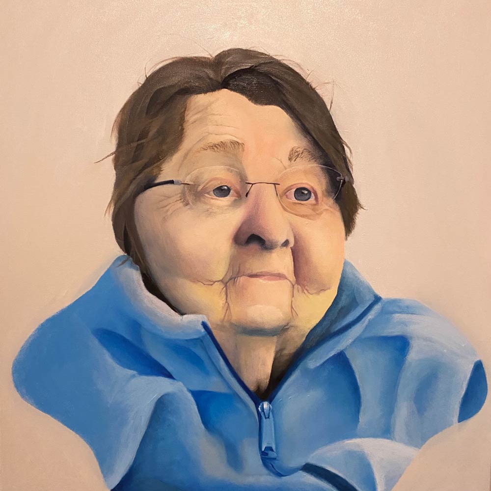 Elderly woman with chubby cheeks in a blue zip-up sweater