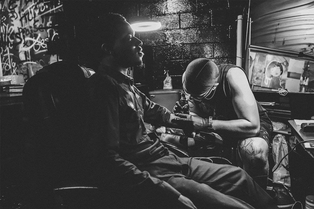 Young man sitting in a chair getting a tattoo