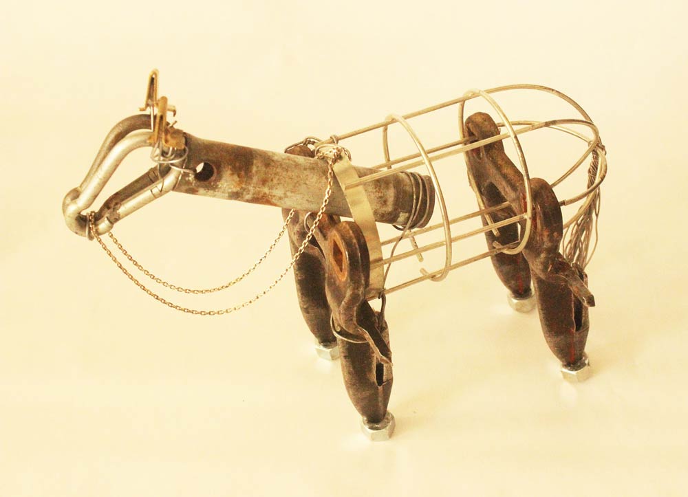 Four-legged sculpture put together with a pipe, carabiners, paper clips, washers, and other pieces of metal