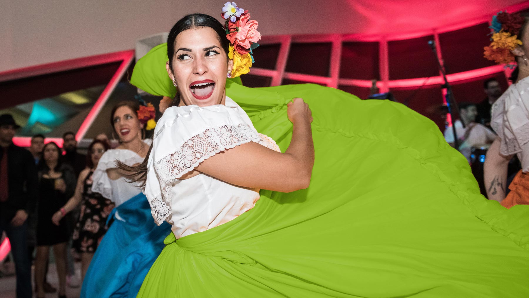 Woman salsa dancing in a bright green skirt