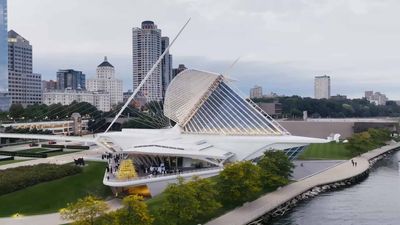 The Milwaukee Art Museum and Milwaukee skyline as seen aerially from over Lake Michigan looking West.