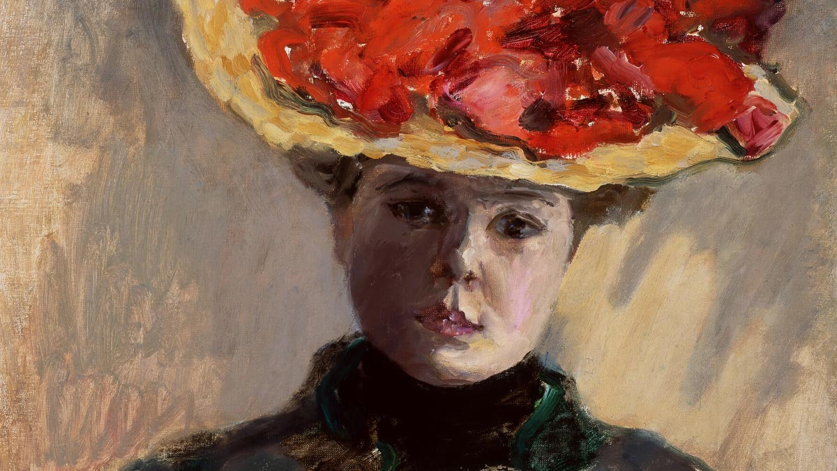 Girl in black neck-high dress and straw hat with red flowers