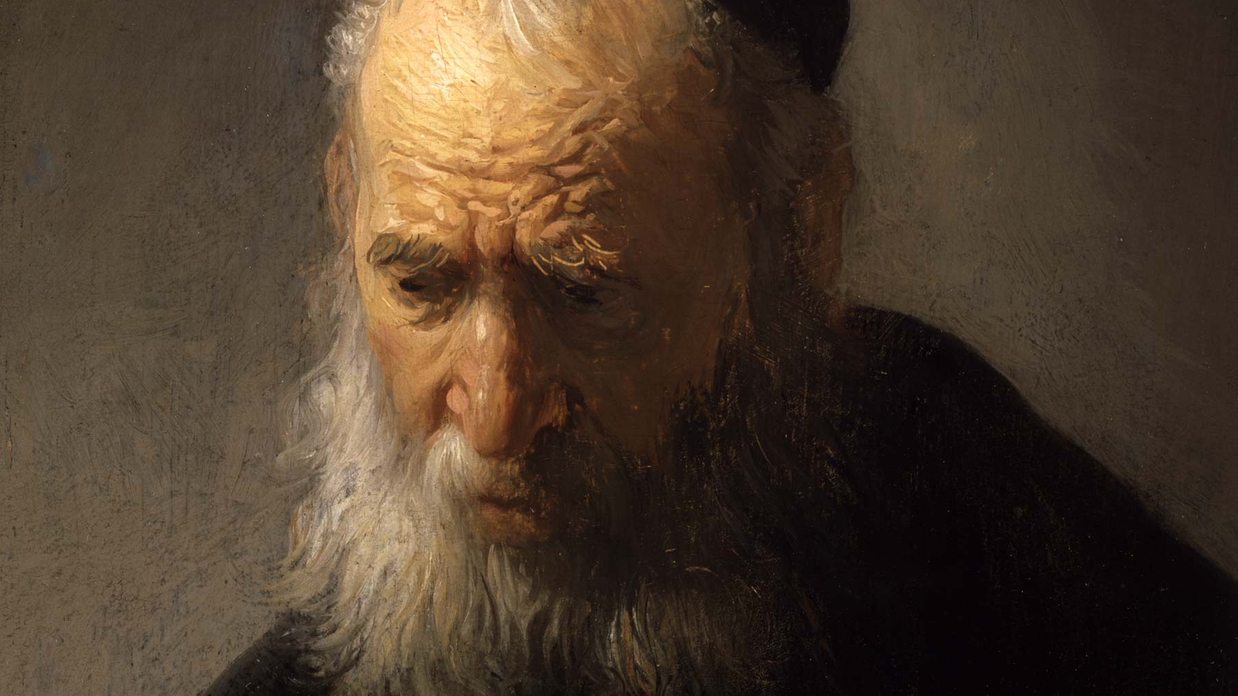 Head of an old man in a black cap