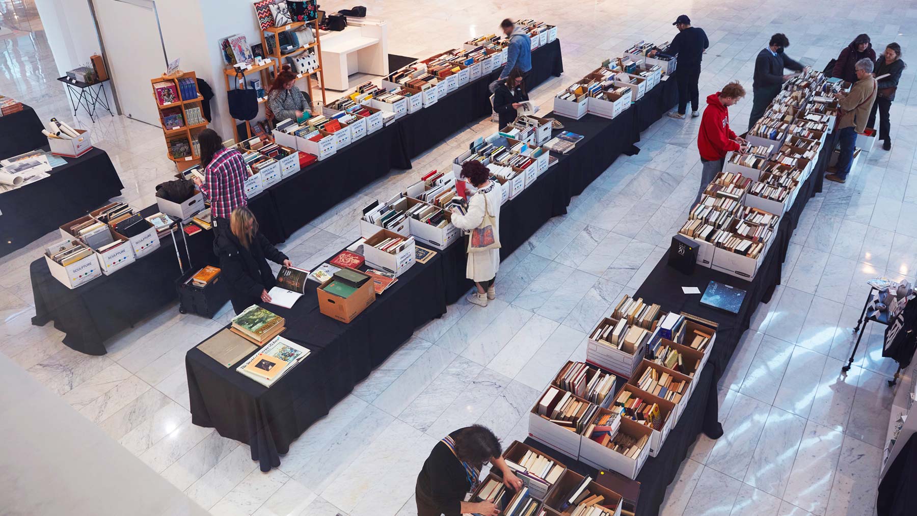Small crowd browsing through books at the Museum book sale