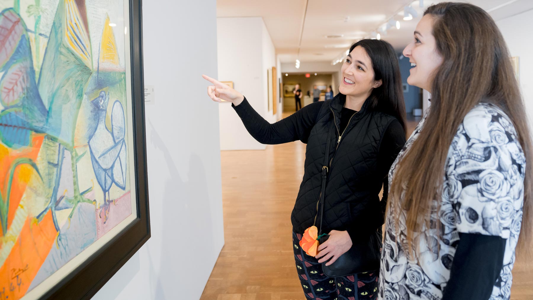 Two women admiring a work of art