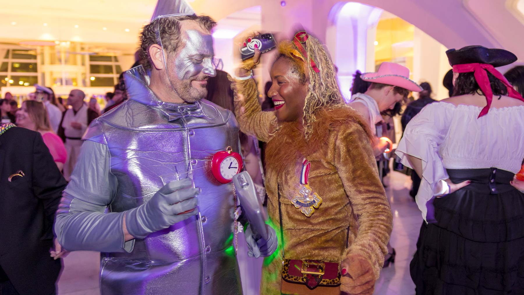 Two adults dressed up as the tinman and the cowardly lion