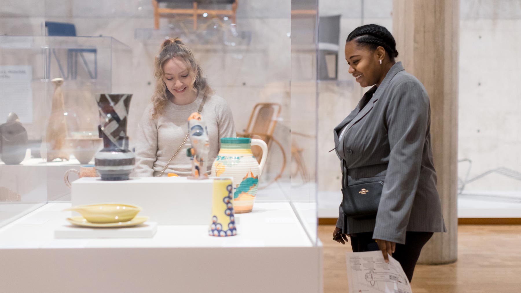 Two young women looking at a work of art
