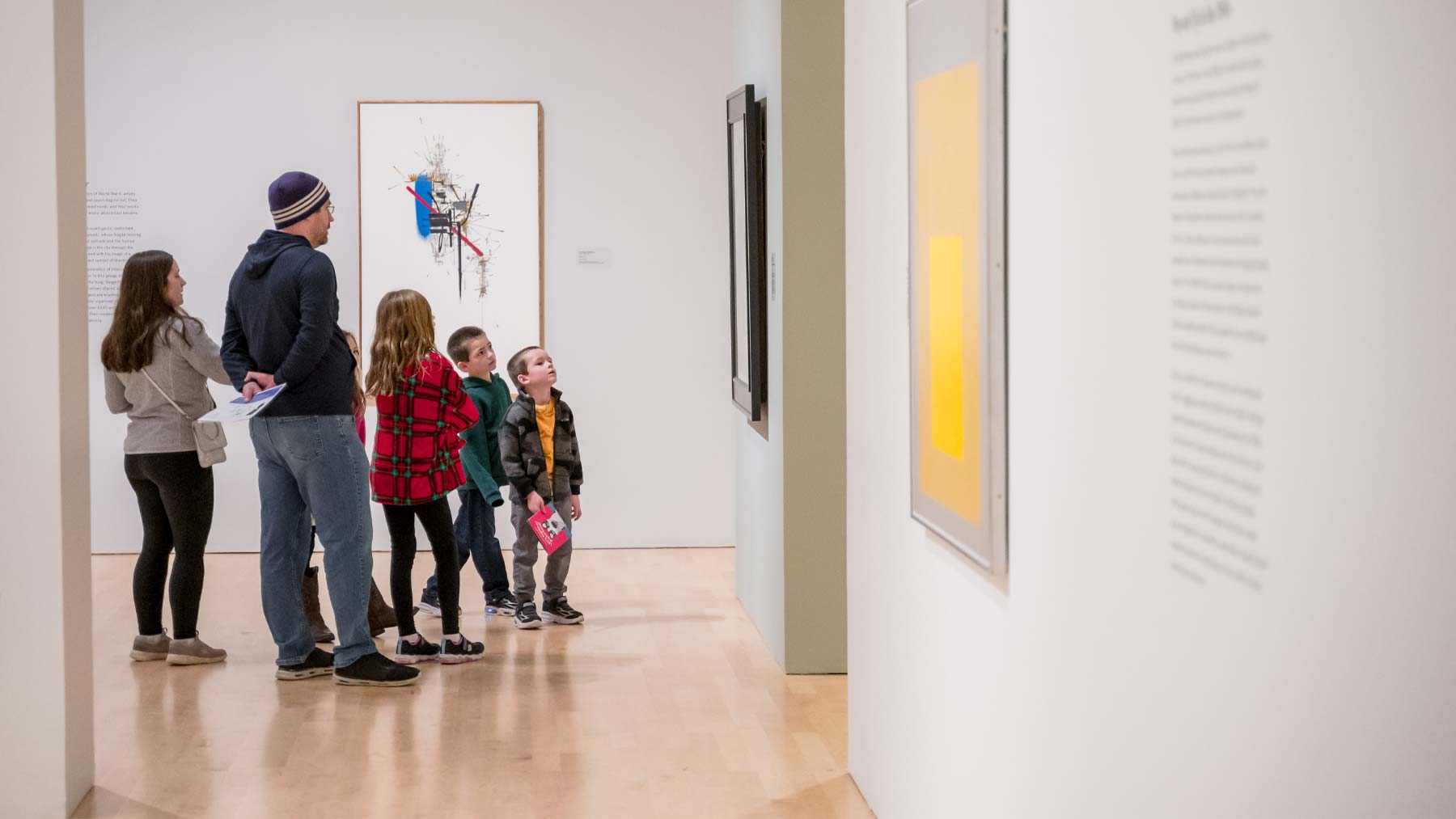 Small group looking at a piece of art on the wall