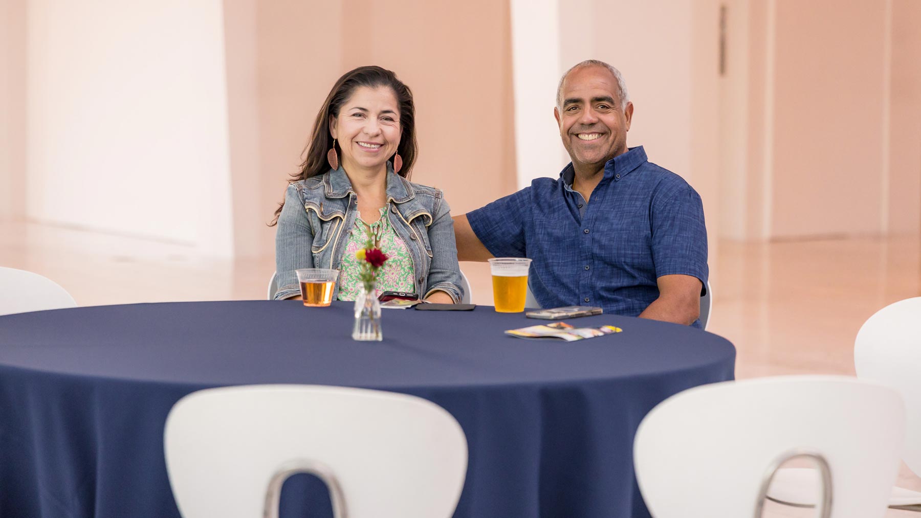Two adults sitting at a table with a dark blue tablecloth