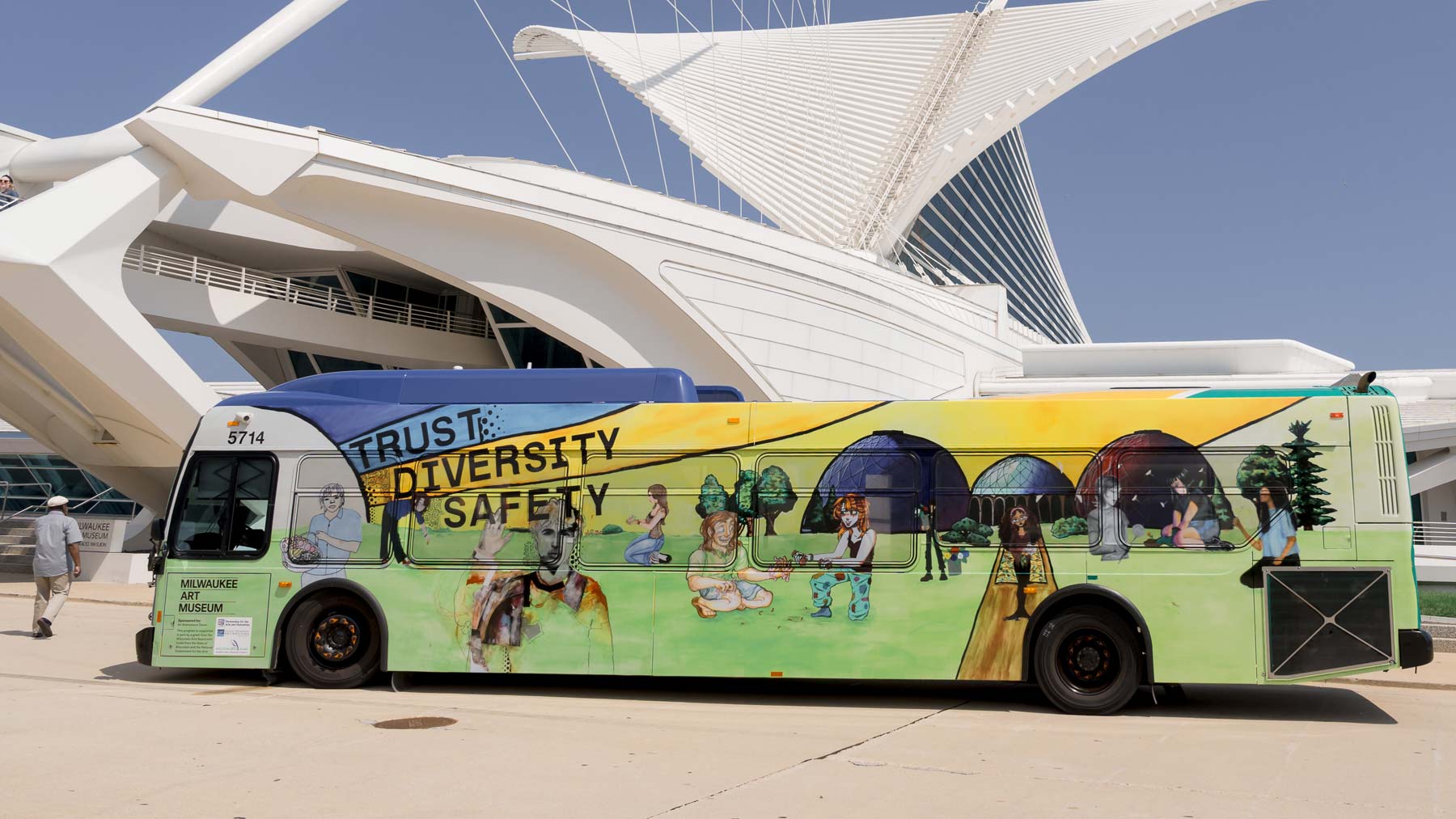 Bus mural, created by ArtXpress interns, parked in front of the Milwaukee Art Museum
