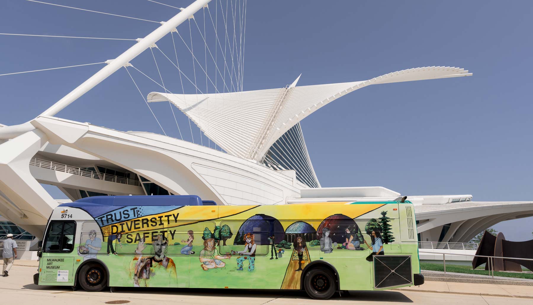 Bus mural, created by ArtXpress interns, parked in front of the Milwaukee Art Museum