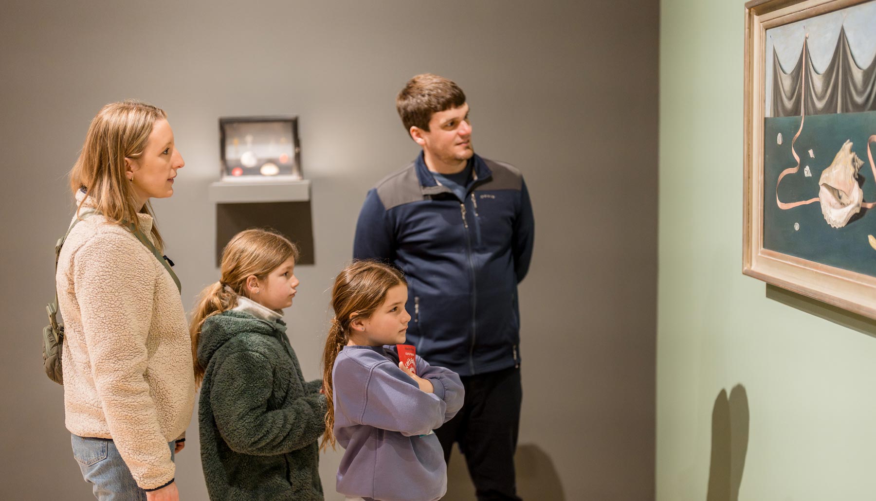 Family of four looking at a work of art