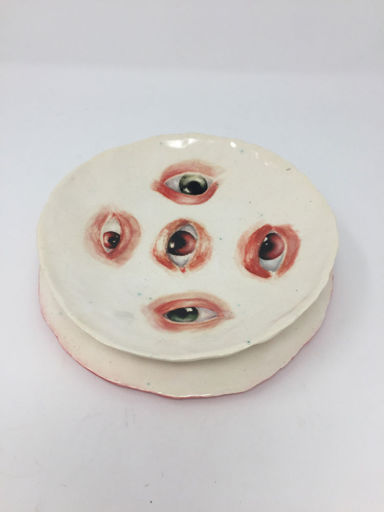 Round ceramic with five painted eyes of different colors
