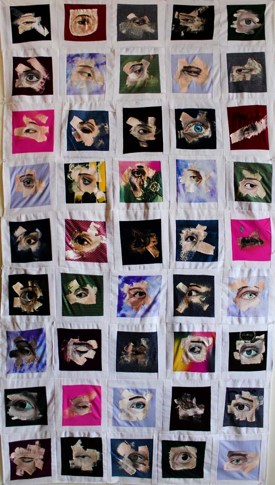 Quilt with different eye cutouts on top of different patterns in each square