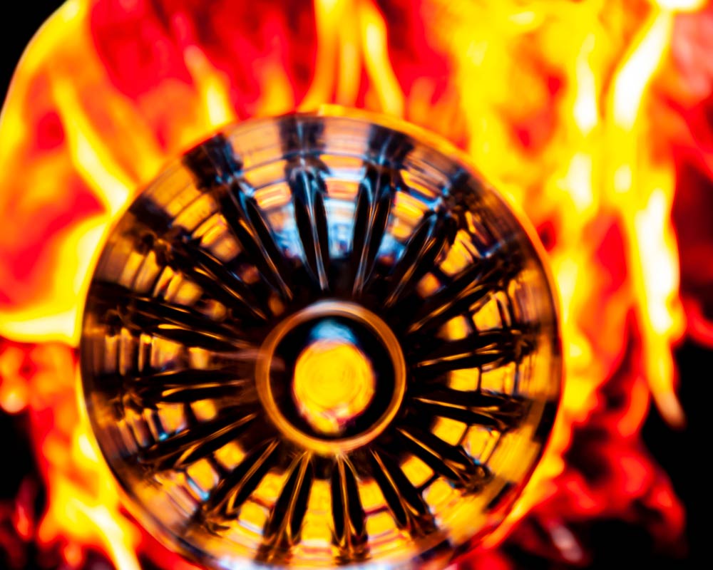 Bright flames surrounding a round metal object