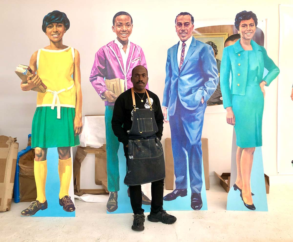 Man standing in front of cutouts of different people